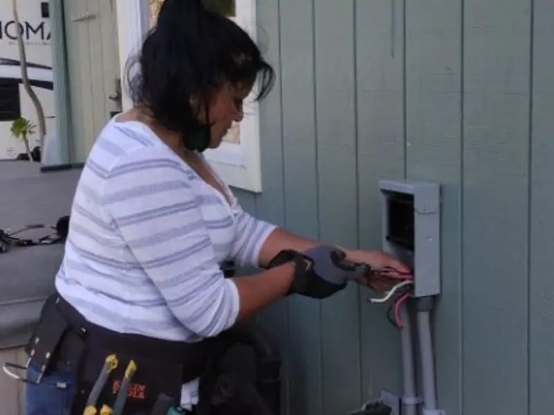 Licensed electrician wiring an exterior subpanel in McCook